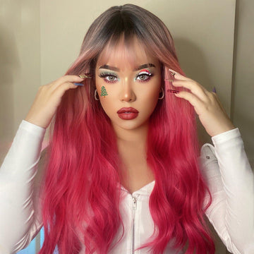 HAIRCUBE 22 inch body wave wig with pink and dark roots styled with bangs and waves