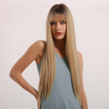 HAIRCUBE straight synthetic wig with bangs in long blonde style worn by model in blue tank top