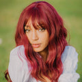 HAIRCUBE 18 inch red wine wig with wavy hair and natural bangs on a woman outdoors