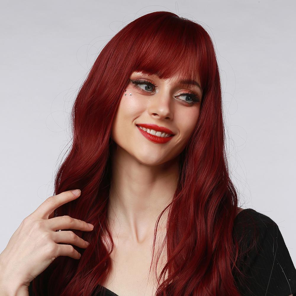 HAIRCUBE 18 inch red wine wig with long wavy hair and full bangs styled on a smiling woman