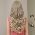 HAIRCUBE 21 inch lace front wig with long wavy blonde hair styled from the back
