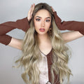 HAIRCUBE 21 inch loose curls wig worn by model with long wavy blonde hair and brown roots
