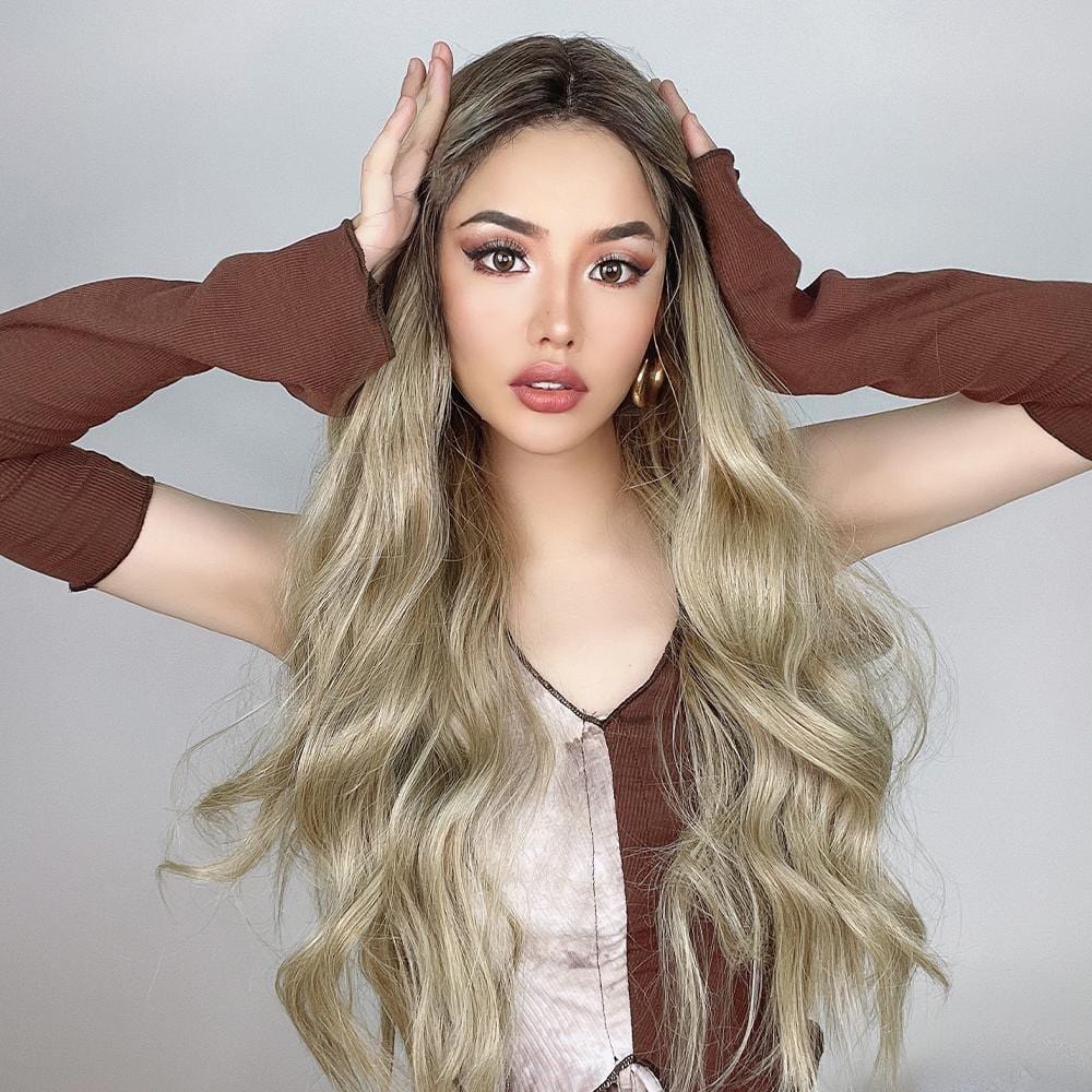 HAIRCUBE 21 inch loose curls wig worn by model with long wavy blonde hair and brown roots