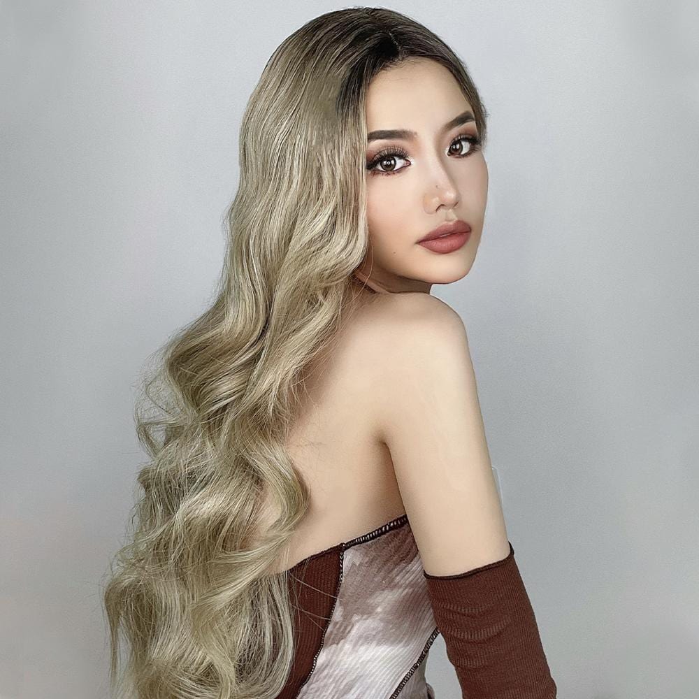 HAIRCUBE 21 inch loose curls wig in blonde shades styled on a model with long flowing hair