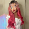 HAIRCUBE 22 inch body wave wig in vibrant pink with dark roots styled on a woman
