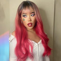 HAIRCUBE 22 inch body wave wig with dark roots and vibrant pink long waves styled on a woman