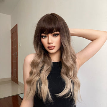 HAIRCUBE 23 inch ombre ash blonde wig with bangs and wavy hair on model wearing black sleeveless top