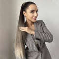 Woman wearing 24 inch synthetic ponytail extension in ombre shades with sleek high ponytail style