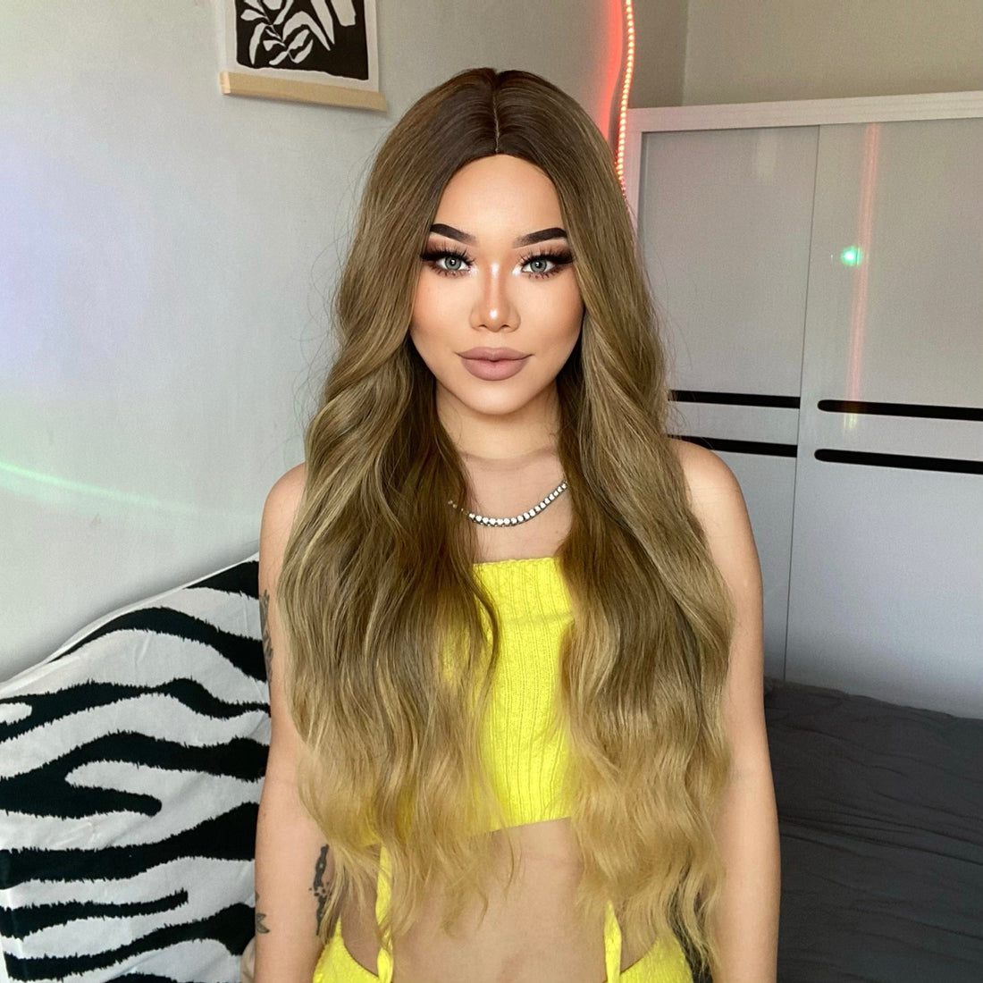 HAIRCUBE 26 inch extra long wavy synthetic wig styled on a woman with ombre light brown to blonde hair