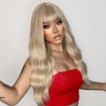 26 inch synthetic wig with bangs by oneNonly in long wavy blonde style worn by model