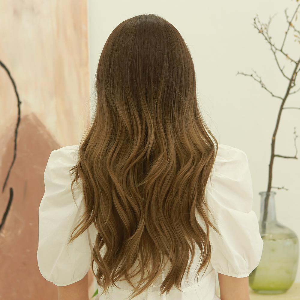 HAIRCUBE dark brown long curly synthetic wig shown from the back on a person wearing a white top