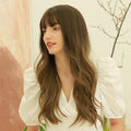 HAIRCUBE dark brown long curly synthetic wig worn by woman with bangs and white puff sleeve blouse