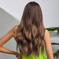 Long wavy ombre brown synthetic wig worn by model with green top showcasing natural hair flow