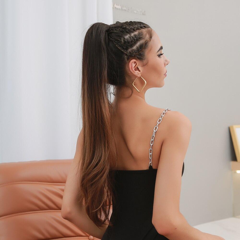 HAIRCUBE 28 inch claw clip ponytail worn by woman with braided hair and gold earrings