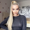 Alan long synthetic ponytail extension worn by woman with blonde hair in black top