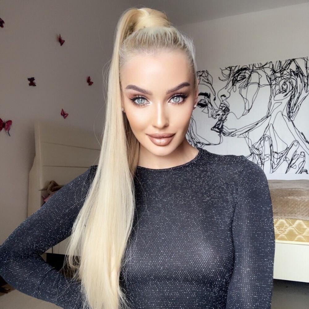 Alan long synthetic ponytail extension worn by woman with blonde hair in black top