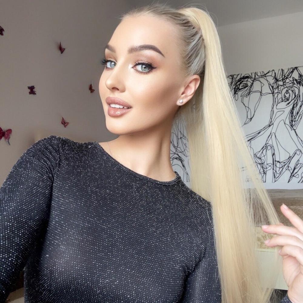 Woman wearing a long synthetic ponytail extension by Alan styled in a high sleek ponytail