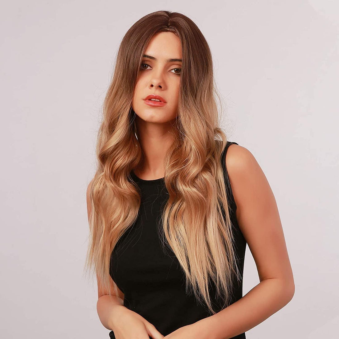 HAIRCUBE long wavy brown to ash blonde wig worn by model with black sleeveless top