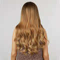 HAIRCUBE long wavy synthetic wig with bangs shown from the back in golden brown color