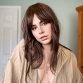 HAIRCUBE natural looking brown human hair wig styled with soft waves on woman