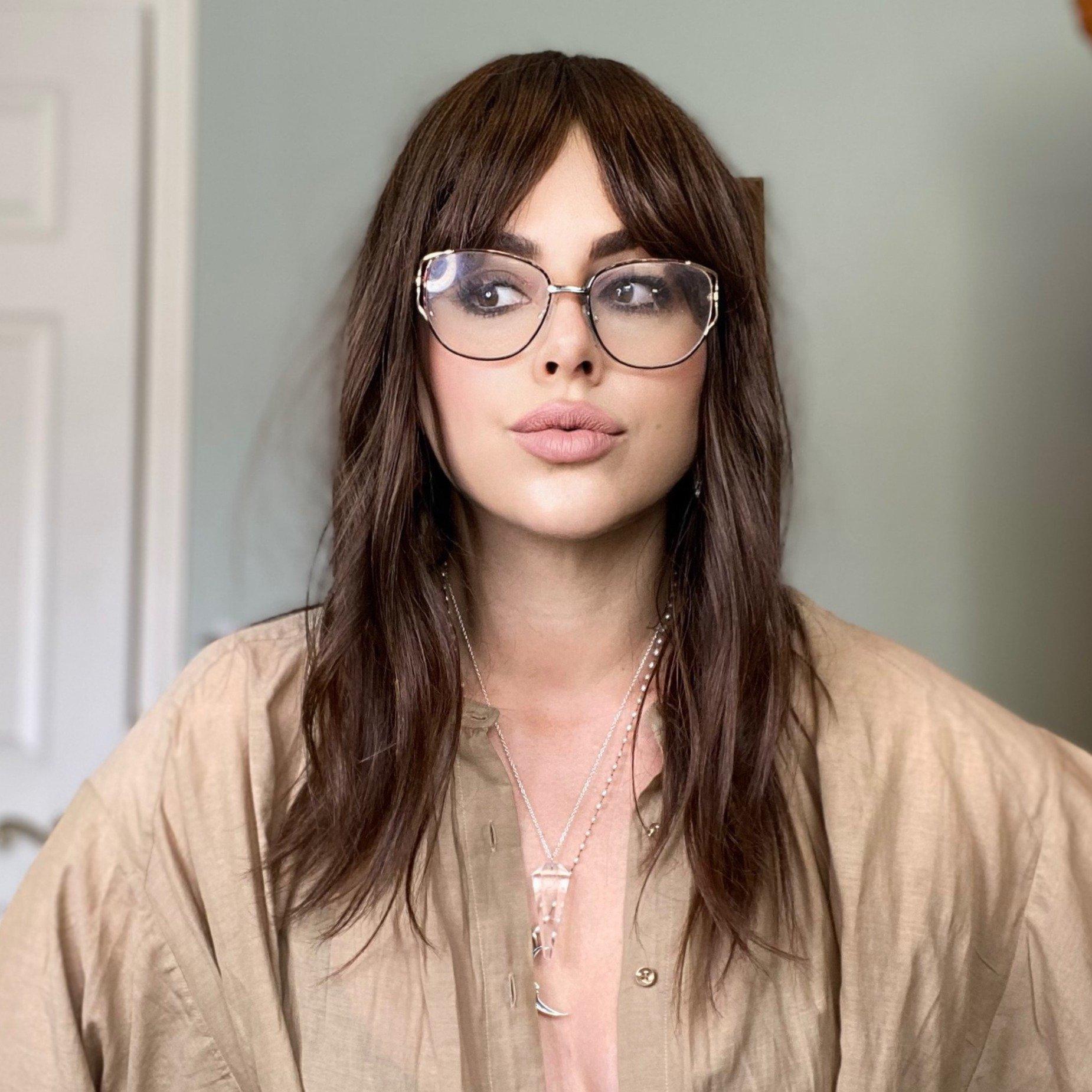 HAIRCUBE natural looking brown human hair wig worn by a woman with glasses and layered hairstyle
