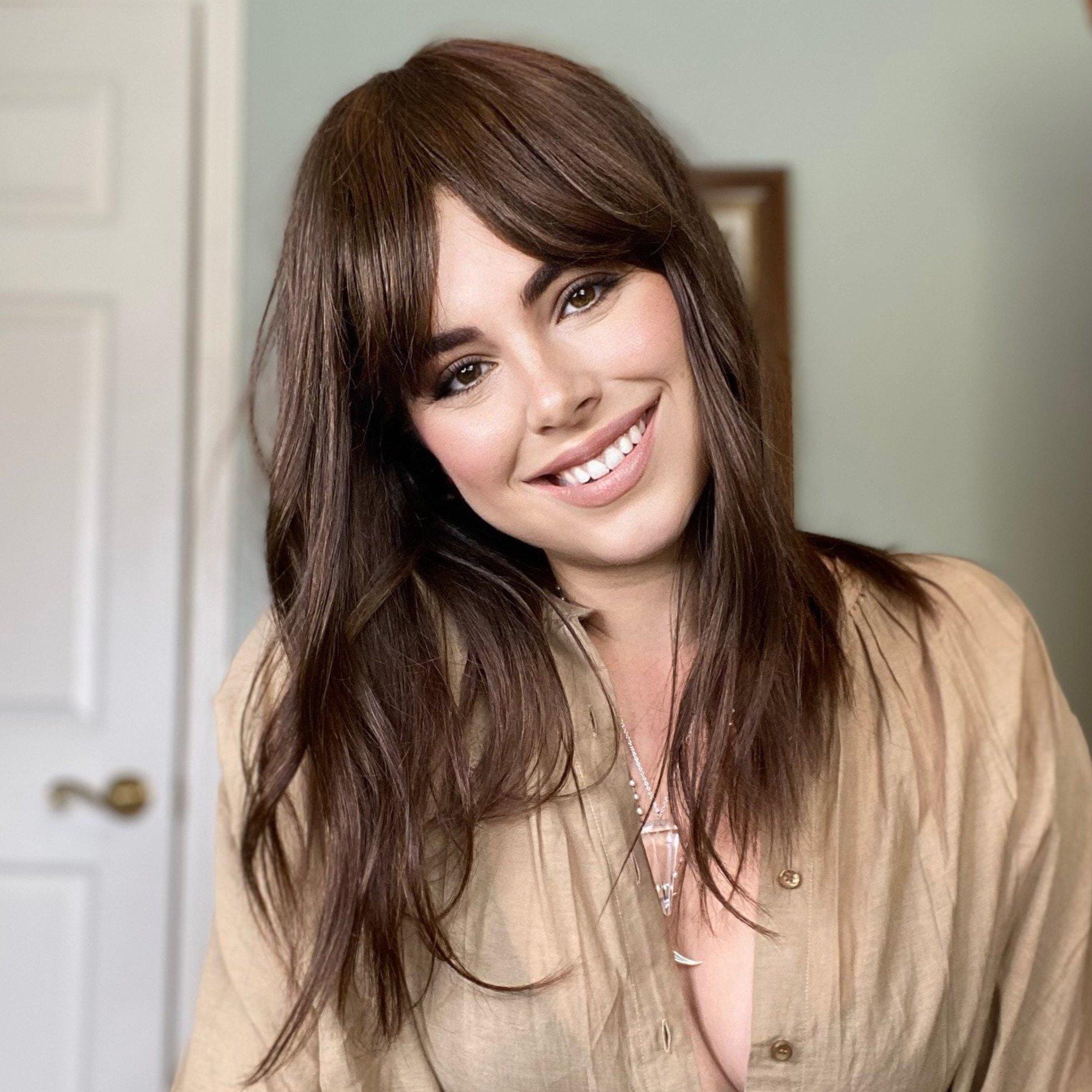 HAIRCUBE natural looking brown human hair wig styled with long layered cut and side bangs