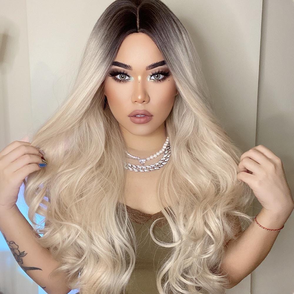 HAIRCUBE 21 inch synthetic wig with long wavy blonde hair and dark roots styled on model