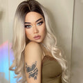 HAIRCUBE 21 inch synthetic wig with long wavy blonde hair and dark roots on model