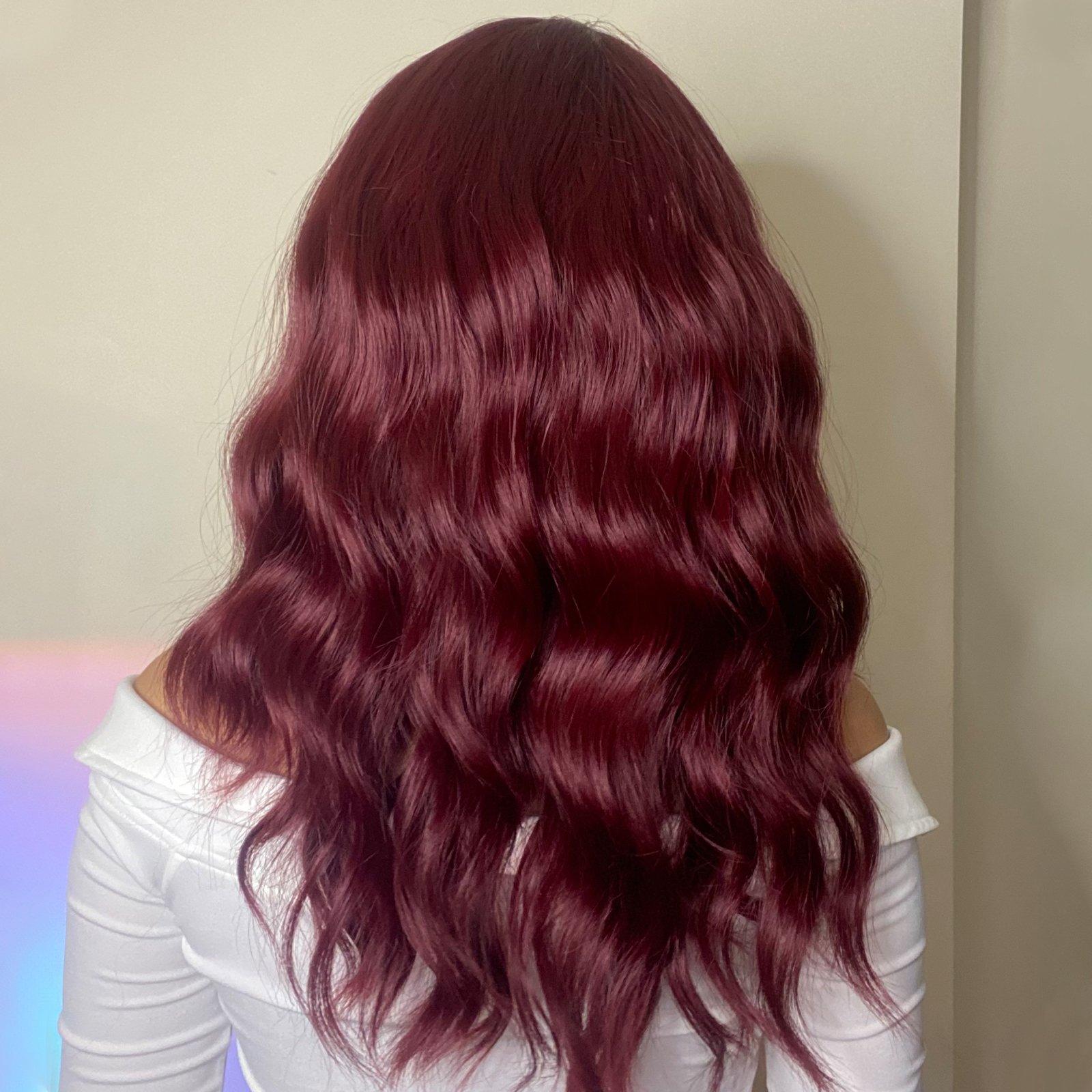 HAIRCUBE red wine spiral wave wig with long wavy hair styled from the back on a model