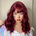 HAIRCUBE red wine spiral wave wig with bangs styled on a woman wearing a white top