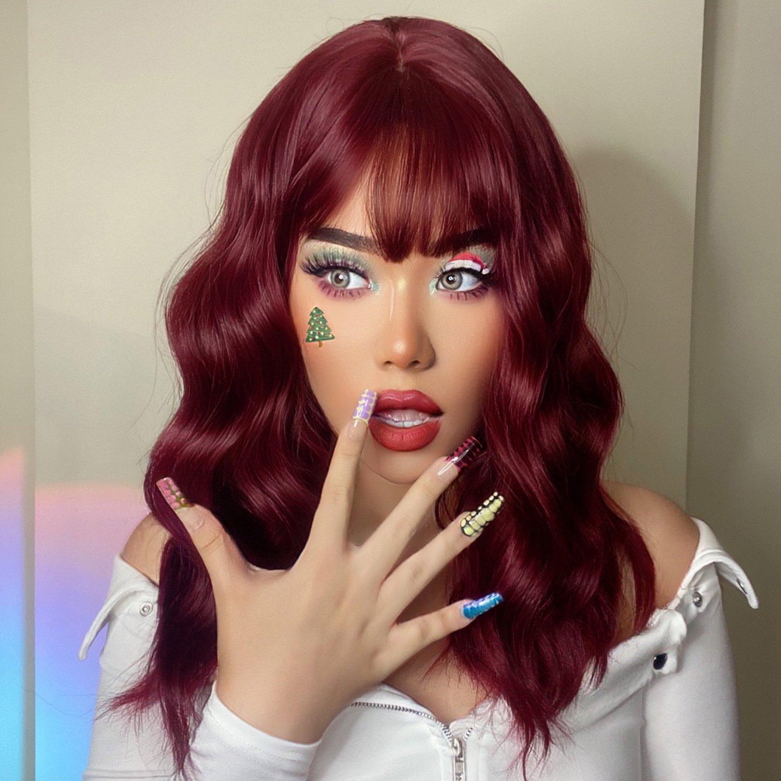 HAIRCUBE red wine spiral wave wig styled with bangs on model with festive makeup