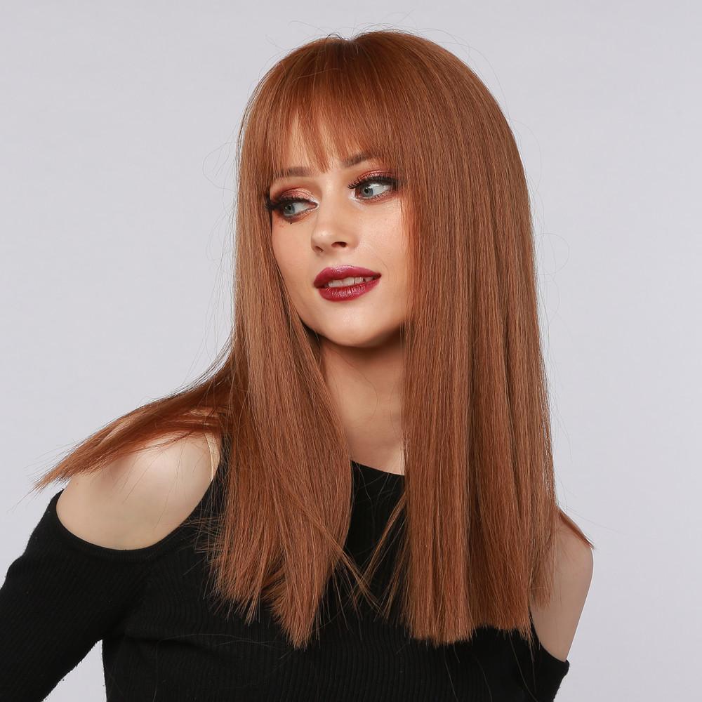 HAIRCUBE reddish brown synthetic wig with straight long hair and bangs on a woman