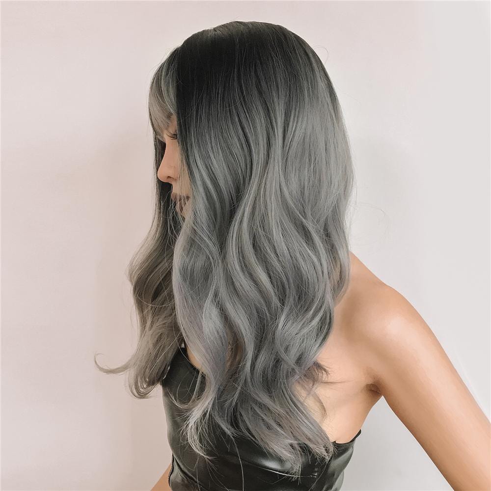HAIRCUBE silver synthetic wig with bangs styled in loose waves on a model wearing a black top
