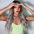 HAIRCUBE smokey grey synthetic wig with long wavy hair styled on woman in green tank top