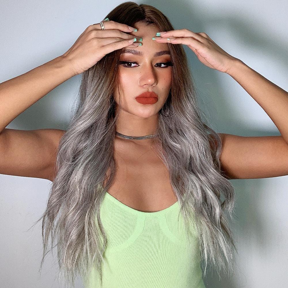 HAIRCUBE smokey grey synthetic wig with long wavy hair styled on woman in green tank top