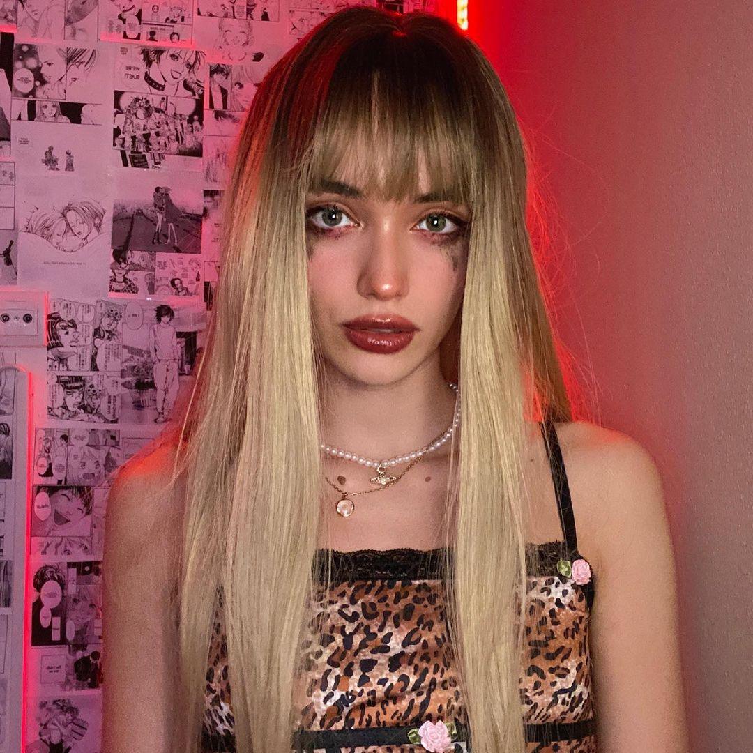 HAIRCUBE straight synthetic wig with bangs in long blonde style worn by woman