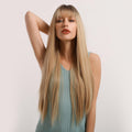 HAIRCUBE straight synthetic wig with bangs in long blonde style worn by woman in blue tank top