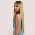 HAIRCUBE straight synthetic wig with bangs on a woman wearing a blue sleeveless top