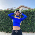 HAIRCUBE straight synthetic wig with bangs worn by woman in blue top and black skirt outdoors