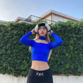 HAIRCUBE straight synthetic wig with bangs worn by woman in blue top and black pants outdoors
