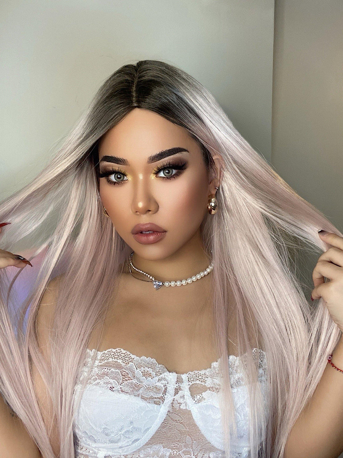 HAIRCUBE vanilla rose gold synthetic wig worn by a model with long straight hair and dark roots