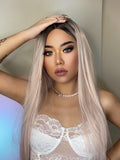 HAIRCUBE vanilla rose gold synthetic wig worn by model with long straight hair and dark roots