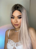 HAIRCUBE vanilla rose gold synthetic wig worn by woman with makeup and white lace top