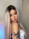 HAIRCUBE vanilla rose gold synthetic wig long straight style with dark roots on woman wearing white lace top
