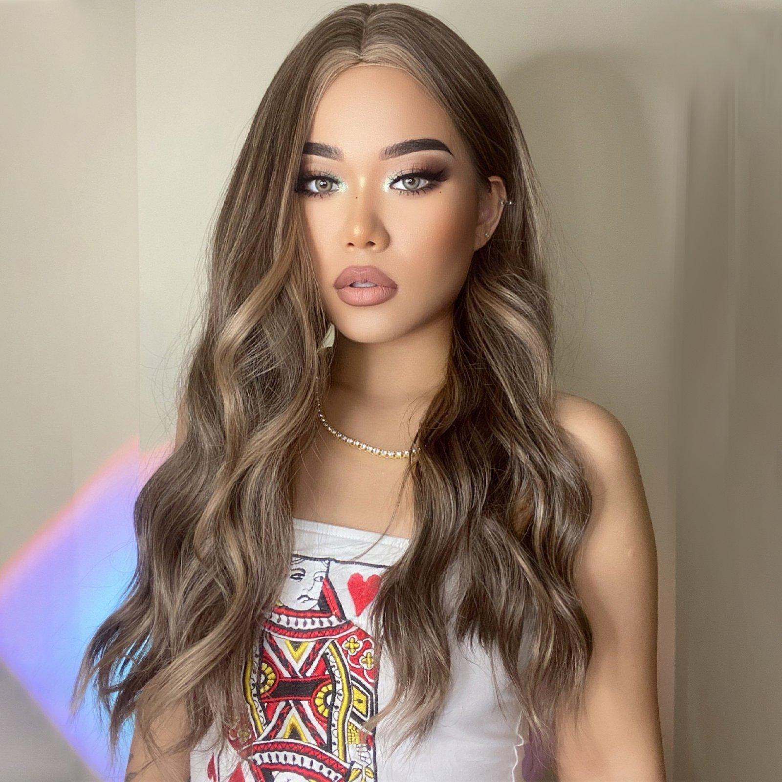 HAIRCUBE 20 inch beach wave wig styled on a woman with long wavy brown hair and subtle highlights