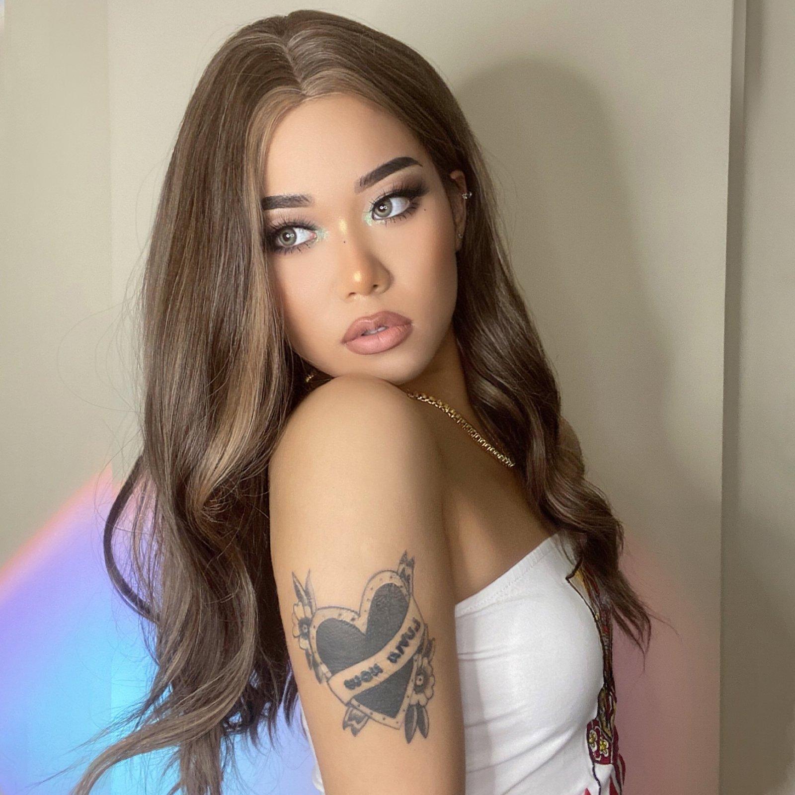 HAIRCUBE 20 inch beach wave wig worn by model with long brown wavy hair and tattoo on arm
