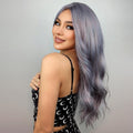 HAIRCUBE 20 inch ombre curly wig in silver gray modeled by a woman with makeup and black patterned dress