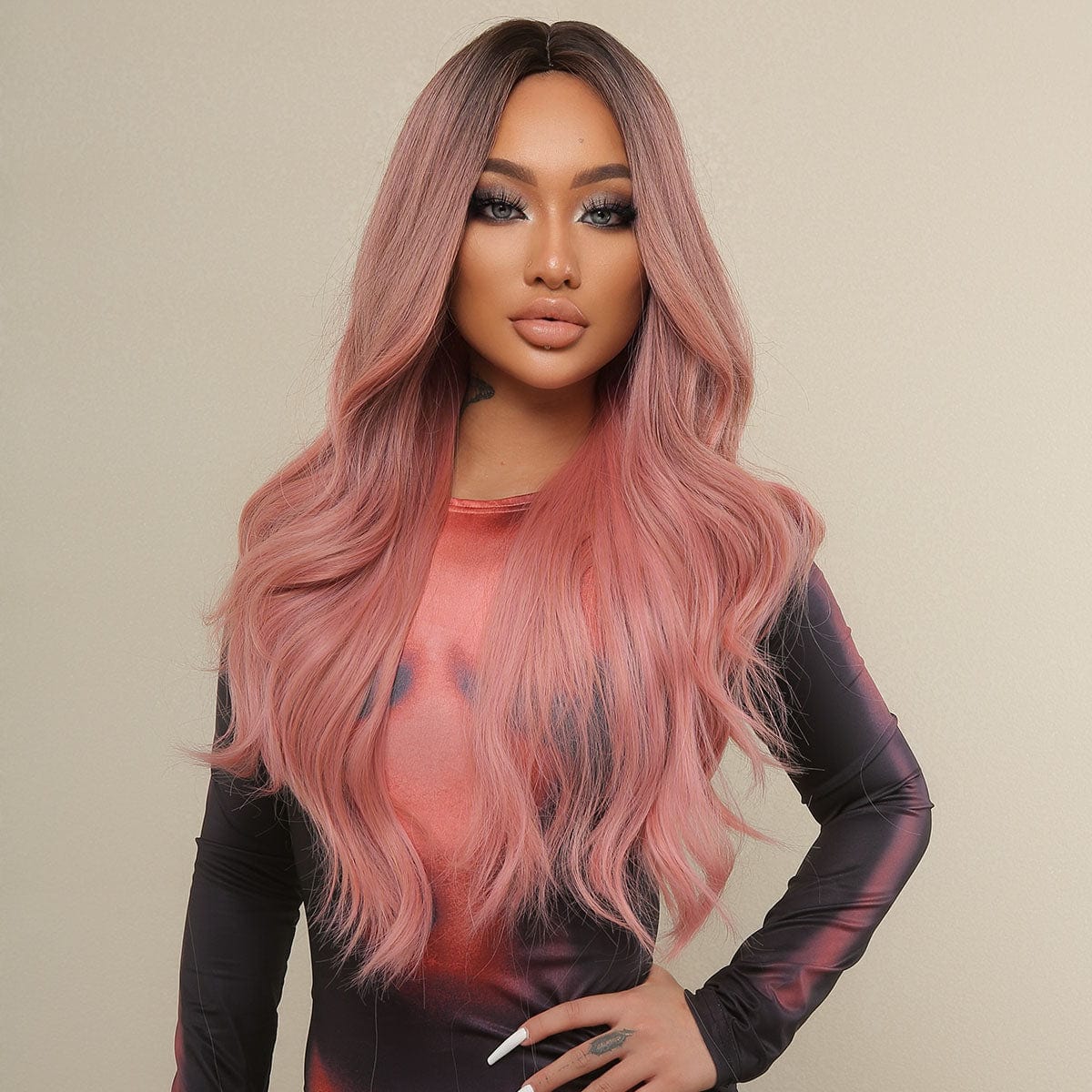 HAIRCUBE 23 inch pink synthetic wig styled in loose waves on a model wearing a black and pink outfit