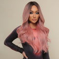 HAIRCUBE 23 inch pink synthetic wig worn by model with long wavy hair and dark roots