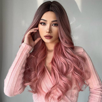 Woman wearing 23 inch pink synthetic wig with long wavy hair styled naturally